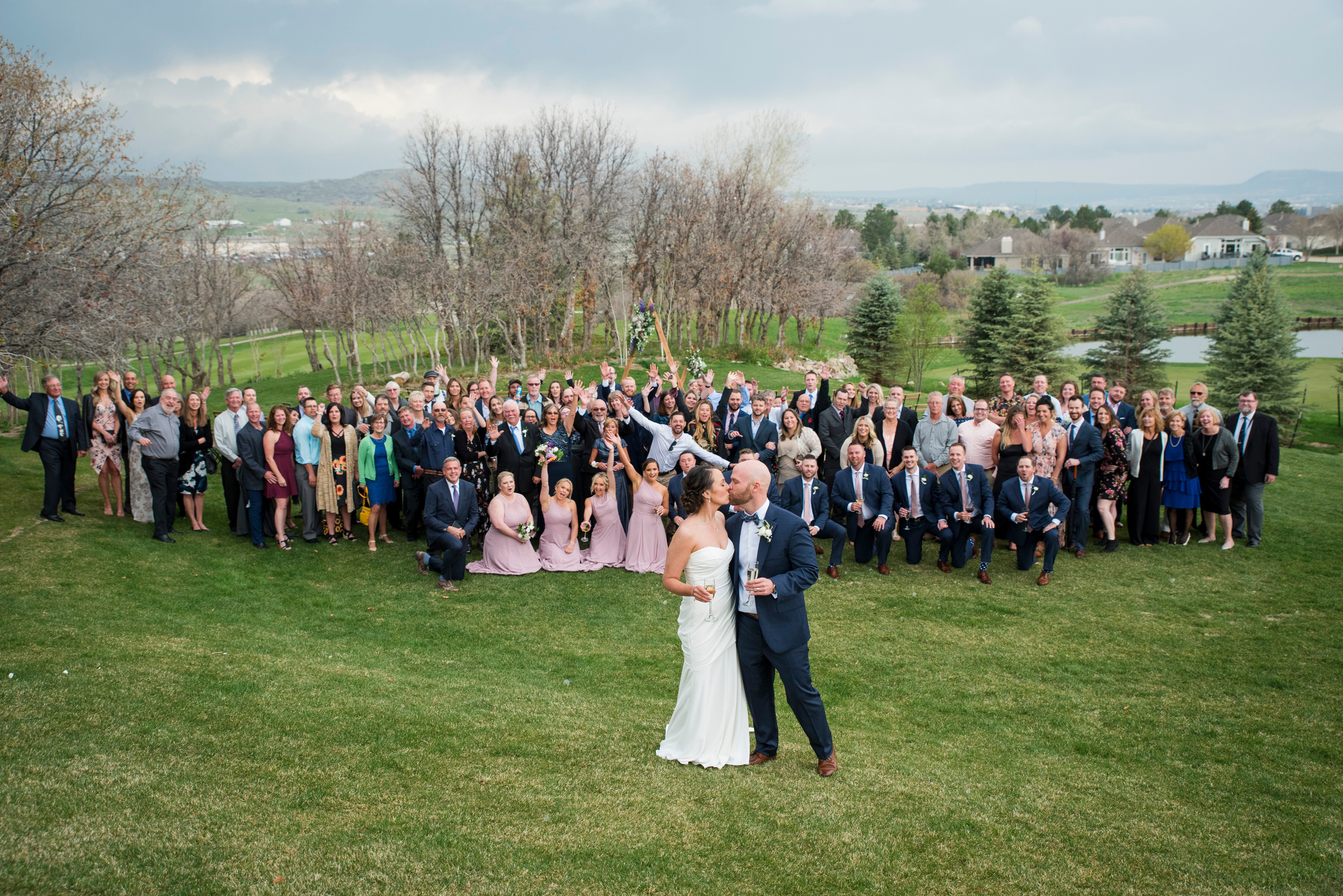 A group of all wedding guests in front of a golf course in Denver, Colorado.